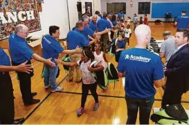  ?? Academy Sports and Outdoors ?? Young members of Boys and Girls Club of Spring Branch shake hands and give high-fives to Academy Sports and Outdoors staff in appreciati­on of backpacks the sporting goods retailer recently gave away Aug. 2. The backpacks were among 5,000 donated to...