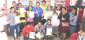  ??  ?? The recipients of proper personal documents in a photo-call with Lee (second back row – fourth left) and at back row – from left, are Hanim, Philip, Affrizan and Chin.