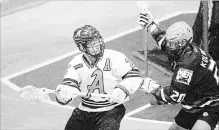  ?? BOB TYMCZYSZYN THE ST. CATHARINES STANDARD ?? St. Catharines Athletics’ Carter Zavitz, left, shown in action against the Burlington Chiefs, scored the winning goal after forcing overtime in a road game against the Peterborou­gh Lakers Friday night.