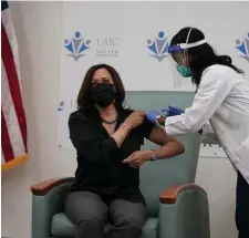  ?? AP ?? ROLLING UP HER SLEEVE: Vice President-elect Kamala Harris receives the Moderna COVID-19 vaccine at United Medical Center in southeast Washington.