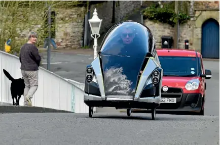  ?? PHOTOS: REUTERS ?? Grant Sinclair rides his invention, the Iris E-Trike electric tricycle, in Chepstow, Wales.