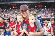  ?? (Courtesy Photo/Chicago White Sox) ?? James McCann at the home run derby with twin sons Christian (left) and Kane.