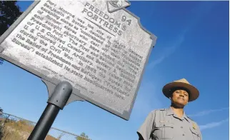  ?? JONATHON GRUENKE/STAFF ?? Fort Monroe’s acting superinten­dent Eola Dance stands in front of the Freedom’s Fortress historical marker Friday afternoon.