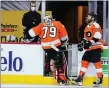  ?? THE ASSOCIATED PRESS FILE ?? Flyers goalie Carter Hart, left, heads for the bench after being pulled early in a loss last week.