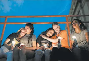  ?? JOHN LOCHER/AP ?? Melody Stout, from left, Hannah Payan, Aaliyah Alba, Sherie Gramlich and Laura Barrios comfort each other during a vigil Aug. 3 in El Paso, Texas. The mass shooting was one of 41 this year, and one of nine to occur in a public place.