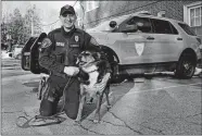  ?? CHARLES KRUPA/AP PHOTO ?? Rhode Island State Police Cpl. Daniel O’Neil poses with his partner, Ruby, a working state police K-9 and former shelter dog, outside the state police barracks in North Kingstown, R.I., on Feb. 16, 2022.