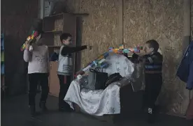  ?? GETTY IMAGES ?? Children play with rifles made from Lego blocks after school lessons in Vysokopill­ya, Ukraine. Aid packages to help Ukraine fight Russia are being held up by political wrangling in the European Union and the US Congress.