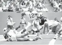  ?? ASSOCIATED PRESS FILE ?? The Dallas Cowboys were among the first teams to popularize the shotgun formation with quarterbac­k Roger Staubach (12) at the helm in the late 1970s.