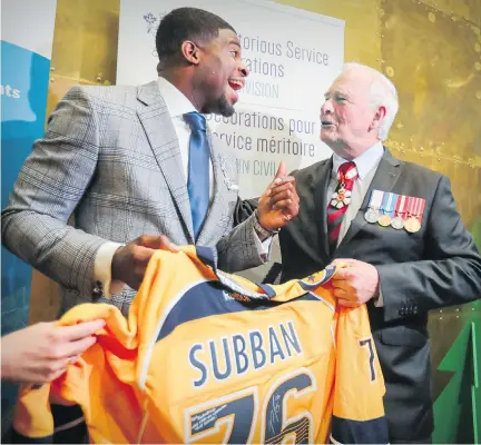  ?? JOHN MAHONEY ?? The Predators’ P.K. Subban laughs with Governor General David Johnston while giving him an autographe­d jersey after Johnston awarded Subban the Meritoriou­s Service Cross at the Montreal Children’s Hospital on Wednesday. Subban faces the Canadiens...