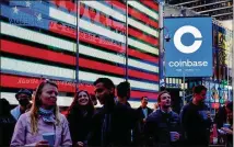  ?? GABBY JONES/NEW YORK TIMES ?? Coinbase employees join Wednesday at Times Square in New York for the company’s initial public offering. It’s the first major cryptocurr­ency startup to go public on a U.S. stock market.