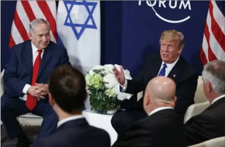  ?? THE ASSOCIATED PRESS ?? Israeli Prime Minister Benjamin Netanyahu listens as President Donald Trump speaks at a meeting at the World Economic Forum in January,