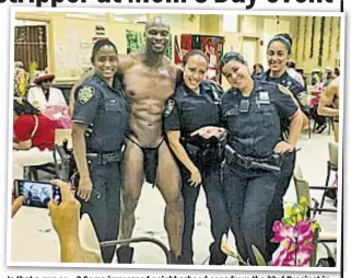 ??  ?? Is that a gun or ...? Some impressed neighborho­od cops from the 33rd Precinct in Washington Heights pose with stripper who came along for a senior center event.