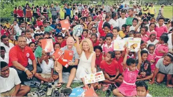  ??  ?? Giving: Paper Plus Group chief executive Rob Smith and Paper Plus books spokeswoma­n Kerre Woodham with students and staff at Nadi Primary School in Fiji.