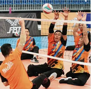  ??  ?? Tall order: The national sitting volleyball players in action during training at MiTEC yesterday. — SAMUEL ONG / The Star