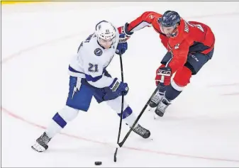  ?? [NICK WASS/THE ASSOCIATED PRESS] ?? Washington Capitals defenseman Matt Niskanen (2) tries to disrupt a pass by Tampa Bay Lightning center Brayden Point (21) during the third period Tuesday in Washington. The Lightning won 4-2.FLYERS 3, CANADIENS 2, OT: MAPLE LEAFS 1, PANTHERS 0: