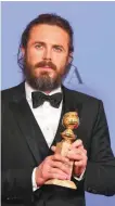  ??  ?? Casey Affleck poses in the press room with the award for best performanc­e by an actor in a motion picture - drama for "Manchester by the Sea".