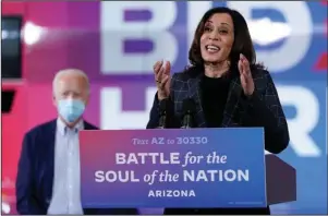  ?? The Associated Press ?? HIATUS: Democratic vice presidenti­al candidate Sen. Kamala Harris, D-Calif., speaks on Oct. 8 at Carpenters Local Union 1912 in Phoenix, as Democratic presidenti­al candidate former vice president Joe Biden listens. Biden’s presidenti­al campaign says Harris will suspend in-person events until Monday, after three people associated with the campaign tested positive for coronaviru­s.