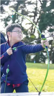  ?? ?? Ray Wang having a fantastic time doing archery - his favourite activity at Allambee.