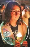  ?? STEVE KINDERMAN/EAU CLAIRE LEADER-TELEGRAM VIA AP ?? Girl Scout Jessica Lauterbach, 12, of Altoona, Wis., attends a candleligh­t vigil Sunday at Halmstad Elementary School in Wisconsin for three fourthgrad­e Girl Scouts and a parent killed Saturday after being struck by a pickup.