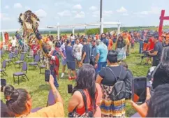  ?? ERIN BORMETT/THE ARGUS LEADER VIA AP ?? Tribal elder Duane Hollow Horn Bear leads a procession in honor of the nine Rosebud children whose remains are being transporte­d home Friday at the Fort Randall Casino on the Yankton Sioux Reservatio­n in South Dakota.