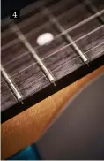  ??  ?? 4 4. By design, there’s no finish above the fret tang, especially if due to temperatur­e or humidity you experience ‘fretsprout’ where the fret ends slightly protrude. “All that’s required,” says Chris, “is to kiss the tangs with a mill smooth or...