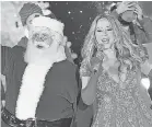  ?? PROVIDED BY WIREIMAGE ?? Santa Claus and Mariah Carey perform at the Christmas tree lighting ceremony at Rockefelle­r Center in 2012.