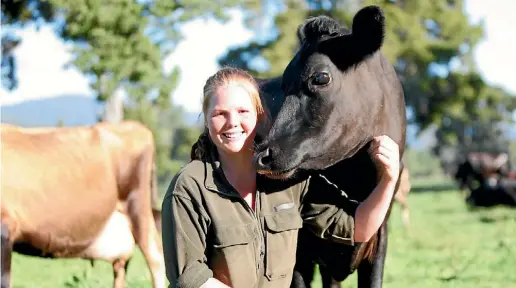  ?? NINA HINDMARSH ?? Jessie Mitchell loves her job as a dairy farmhand.