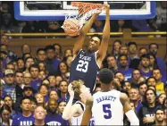  ?? Lance King / Getty Images ?? Yale’s Jordan Bruner dunks over Duke’s Alex O’Connell and RJ Barrett (5) at Cameron Indoor Stadium on Dec. 8 in Durham, N.C.