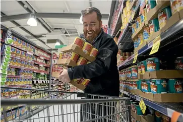  ??  ?? Owning supermarke­ts is a winner for Investore. The Salvation Army’s Jacob Howan is shown during the Countdown’s 90-second Grocery Grab for the Salvation Army last month.