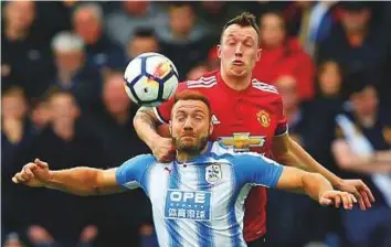  ?? Reuters ?? Manchester United’s Phil Jones fights for the ball with Huddersfie­ld Town’s Laurent. United lost 1-2 to Huddersfie­ld.