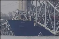 ?? MATT ROURKE — THE ASSOCIATED PRESS ?? A container ship rests against wreckage of the Francis Scott Key Bridge on Tuesday as seen from Sparrows Point, Md.