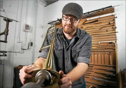  ?? SUBMITTED PHOTO ?? The National Associatio­n of Music Merchants recently recognized Exeter-based Zeswitz Music with its Best Store Turnaround Award. Shown here, Zeswitz employee Dane Mountain works on a trombone.