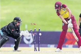  ?? COURTESY OF ICC MEDIA ?? Shunelle Sawh (right) of West Indies is bowled by Anna Browning(out of picture) as wicketkeep­er Isabella Gaze watches the action during their ICC Women Under19 World Cup yesterday.