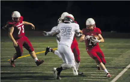  ?? Christian Monterrosa/The Signal ?? (Above) Santa Clarita Christian running back Lucas Pettee (25) runs the ball to the edge against Trinity Classical Academy on Saturday. (Below) SCCS wide receiver Caden Brenner stiff arms a Trinity defender on Saturday.