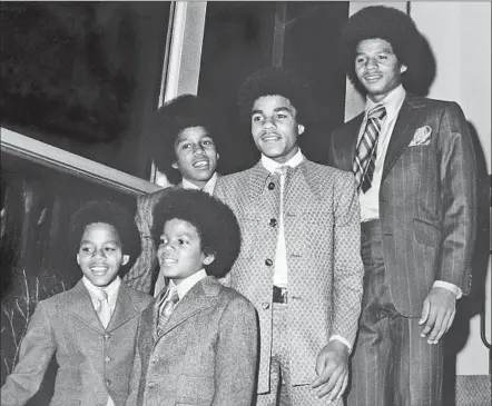  ?? Cal State Nor thridge ?? AMONG THE IMAGES in the African American Photograph­y Collection at Cal State Northridge’s Institute for Arts & Media is Guy Crowder’s shot of a young Jackson 5 (Michael is second from left). Crowder and others worked largely as freelancer­s for black...