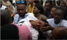  ??  ?? The mother of Samuel de Souza Rosa, one of the 10 young soccer players killed in a fire at the training ground of Brazilian soccer club Flamengo, is carried by mourners during his funeral in Sao Joao de Meriti, Brazil, Monday. The death of de Souza Rosa and his teammates has shed a tragic light on the state of shoddy infrastruc­ture and lax oversight in Latin America’s largest nation. AP PhoTo/Leo correA