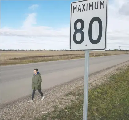  ?? BRANDON HARDER ?? Leshae Bell, 18, walks on the shoulder of Dewdney Avenue on the city’s west end to the nearest bus stop 1.6 kilometres from her Westerra home. There is no sidewalk or separation from cars that whiz past at 80 km/h, a situation she feels is even riskier after dark or on foggy days.