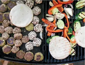  ??  ?? The vegetables and rissoles can be cooked side by side on the barbecue, and the pita pockets can be warmed on top.