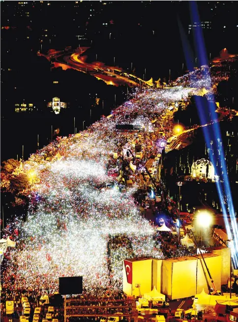  ??  ?? People gather for a ceremony marking the first anniversar­y of the attempted coup at the Bosphorus Bridge in Istanbul. — Reuters photo