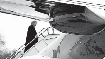  ?? JACQUELYN MARTIN/AP ?? President Donald Trump boards Air Force One after addressing the American Farm Bureau Federation convention in New Orleans, where he defended holding out for wall funding.