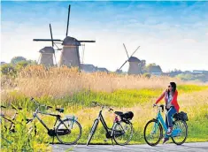  ?? ?? Freewheeli­ng: a cyclist in the village of Kinderdijk, in the south of the Netherland­s