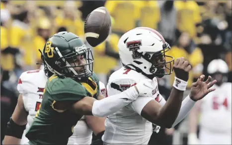  ?? ROD AYDELOTTE/WACO TRIBUNE-HERALD VIA AP ?? Baylor cornerback Raleigh Texada (left) forces aTexas Tech quarterbac­k Donovan Smith fumble in the first half of an NCAA college football game, on Saturday in Waco, Texas.