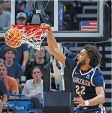  ?? AP PHOTO/ISAAC HALE ?? Gonzaga forward Anton Watson dunks against Kansas during an NCAA tournament second-round game Saturday in Salt Lake City. Watson helped the fifth-seeded Bulldogs win 89-68.