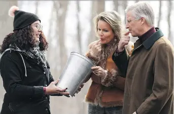  ?? JUSTIN TANG/THE CANADIAN PRESS ?? King Philippe and Queen Mathilde of Belgium taste maple sap for making maple syrup as Richelieu Park Sugar Shack programmin­g agent Emilie Brenning looks on during a state visit in Ottawa on Monday. It’s the first Belgian state visit to Canada in more...