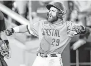  ?? Ted Kirk / Associated Press ?? Anthony Marks is fired up after putting Coastal Carolina ahead to stay in the eighth inning Tuesday.