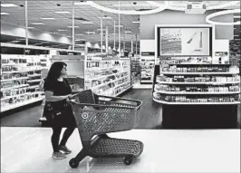  ?? ERIC GAY/AP ?? A shopper walks through the cosmetic department at a Target store in San Antonio, Texas.