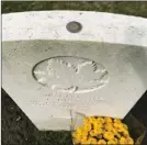  ?? A.J. WILLIAMS/Special to The Okanagan Weekend ?? A Penticton couple laid flowers and and placed a toonie on the headstone their great uncle Charles Brown, a soldier in the First World War who was buried Woods Cemetery in Belgium.