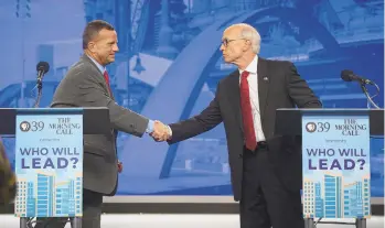  ?? RICK KINTZEL/THE MORNING CALL ?? Northampto­n County District Attorney candidates Republican Tom Carroll, left, and Democrat Terry Houck shake hands Monday after a debate at the PBS39 studios in Bethlehem. The debate is part of PBS39’s “Who Will Lead?” series.