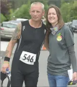  ??  ?? Elber Twomey congratula­tes Tom O’Riordan after completing both the cycle and Road Run at the Twomey Remlrial hosting in Meelin. Picture John Tarrant