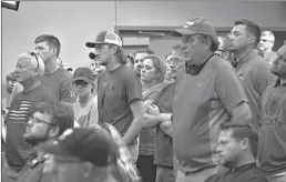  ?? ERIN BORMETT/THE ARGUS LEADER ?? People wear red in solidarity against a citywide mask mandate during a city council meeting Sept. 2 in Brookings, South Dakota. COVID-19 infections are on the rise in the Dakotas.